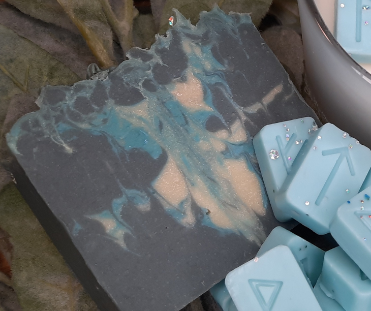 Handmade soap bars with decorative elements on a natural background